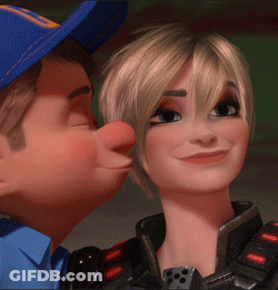 A Man In A Blue Hat Kisses A Woman On The Nose GIF