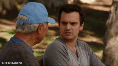 A Man In A Blue Hat Sits Next To Another Man GIF