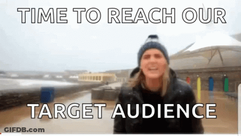A Man In A Blue Hat Stands In Front Of A Sign That Says " Time To Reach Our Target Audience " GIF