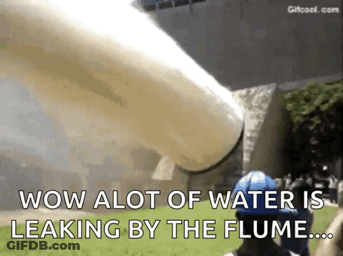 A Man In A Blue Helmet Is Standing In Front Of A Large Pipe That Says Wow Alot Of Water Is Leaking By The Flume GIF