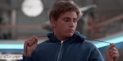 Man In Blue Hoodie Holding Rope In Front Of Breakfast Club Sign GIF