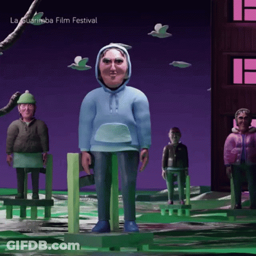 A Man In A Blue Hoodie Is Standing In Front Of A Sign That Says La Guarimba Film Festival On It GIF
