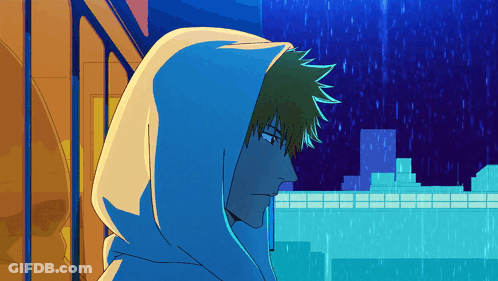 A Man In A Blue Hoodie Stands In Front Of A City GIF