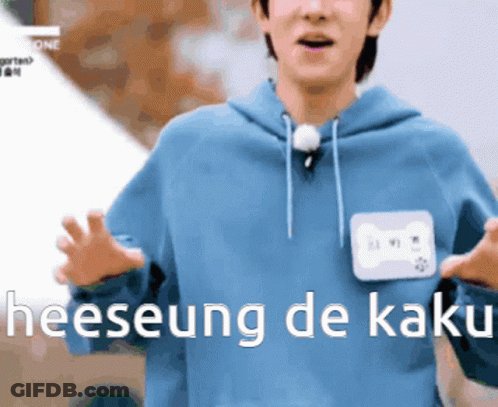 A Man In A Blue Hoodie With A Name Tag That Says Heeseung De Kaki On It GIF
