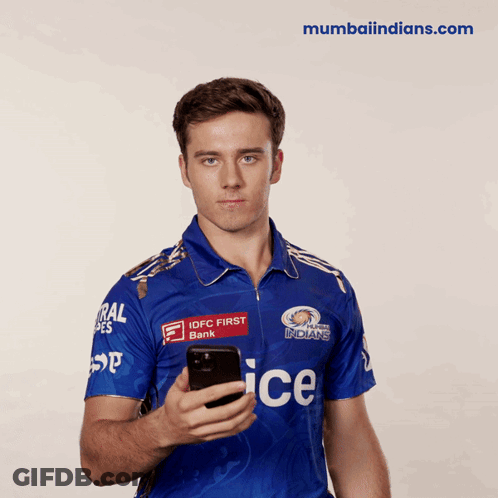 A Man In A Blue Ice Jersey Holds A Cellphone GIF
