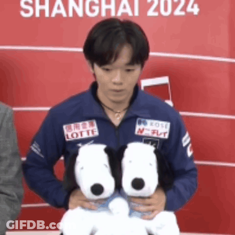 A Man In A Blue Jacket Holding Two Stuffed Snoopy Dogs GIF