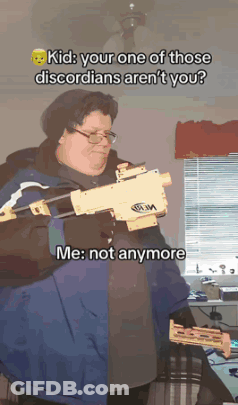 A Man In A Blue Jacket Holds A Nerf Gun GIF