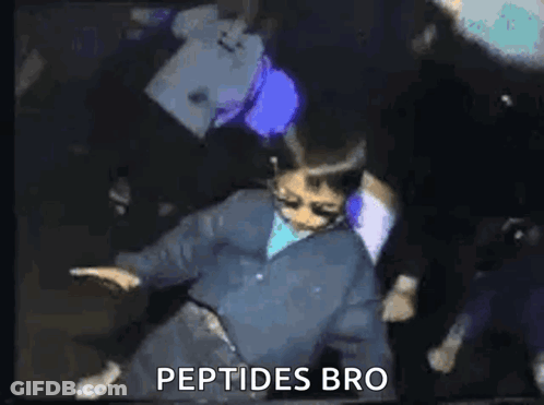A Man In A Blue Jacket Is Dancing In A Dark Room With The Words `` Peptides Bro '' Written On The Bottom . GIF