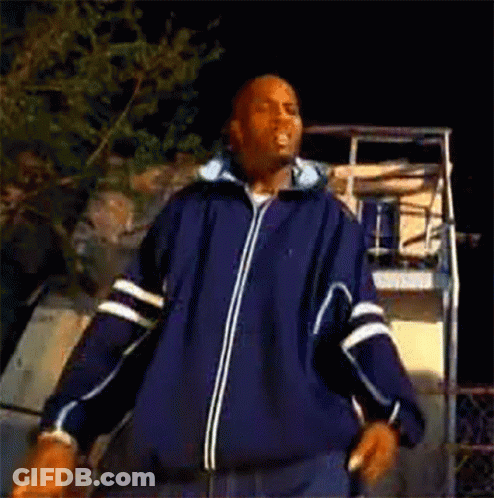 A Man In A Blue Jacket Is Dancing In Front Of A Basketball Hoop . GIF
