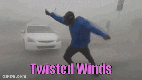 A Man In A Blue Jacket Is Dancing In Front Of A White Car With The Words Twisted Winds Below Him . GIF
