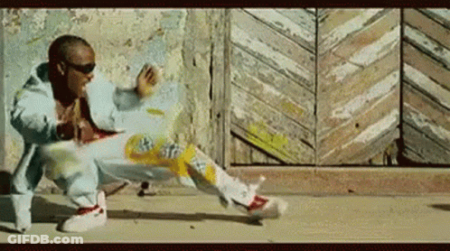 A Man In A Blue Jacket Is Doing A Trick On The Ground GIF