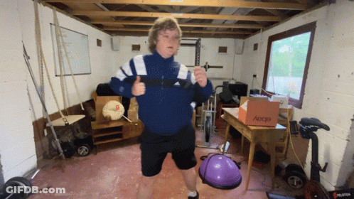 A Man In A Blue Jacket Is Giving A Thumbs Up In A Gym With A Box That Says Ebay On It GIF