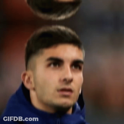 A Man In A Blue Jacket Is Looking Up At Something GIF