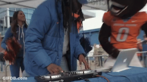 A Man In A Blue Jacket Is Playing A Pioneer Dj GIF