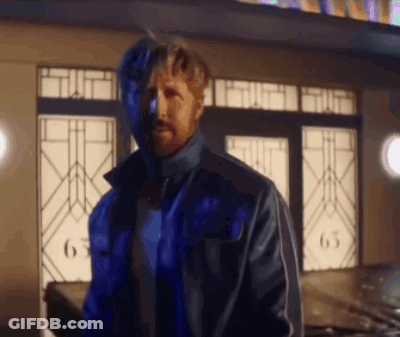 A Man In A Blue Jacket Is Standing In Front Of A Building With The Number 63 On It GIF