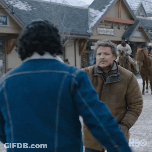 A Man In A Blue Jacket Is Standing Next To Another Man In A Brown Jacket GIF