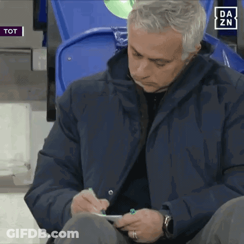 A Man In A Blue Jacket Is Writing On A Piece Of Paper With A Da Zn Logo In The Background GIF
