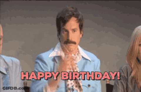 A Man In A Blue Jacket Says Happy Birthday In Red Letters GIF