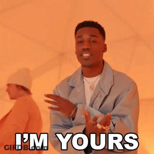 A Man In A Blue Jacket Says " I 'M Yours " In Front Of Another Man GIF