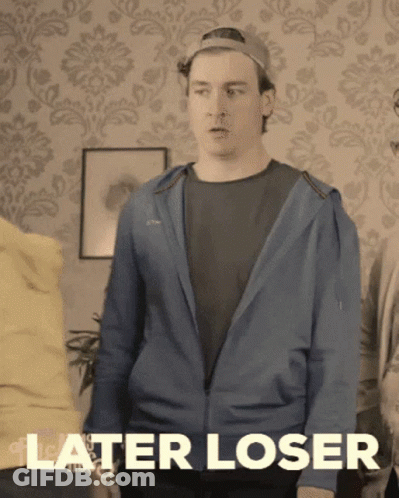 A Man In A Blue Jacket Says " Later Loser " In Front Of A Patterned Wall GIF