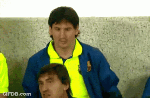 A Man In A Blue Jacket With A Yellow Collar Is Standing Next To Another Man In A Yellow Shirt GIF