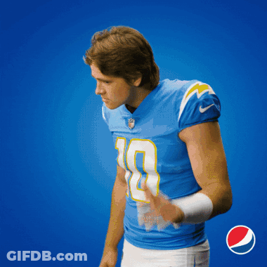A Man In A Blue Jersey With The Number 9 On It Holds His Hand To His Ear GIF