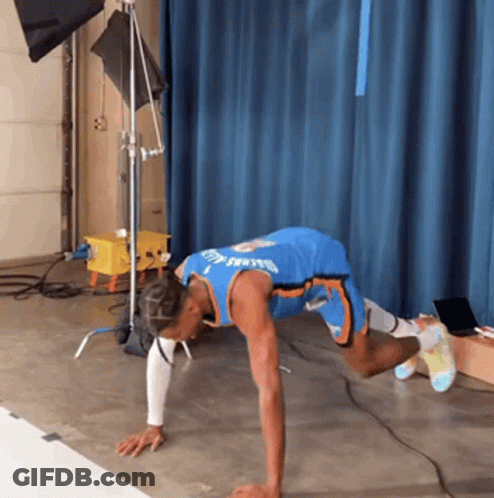 A Man In A Blue Jersey With The Word Thunder On It Is Doing Push Ups On The Floor GIF