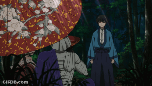 A Man In A Blue Kimono Stands In Front Of A Red Umbrella GIF