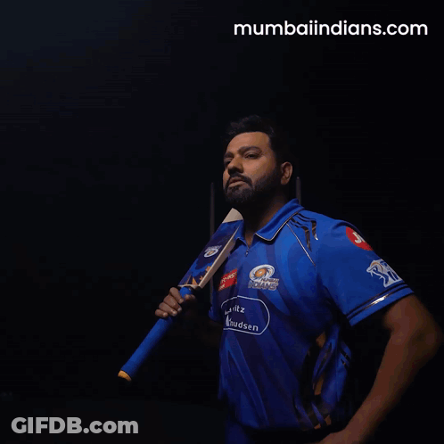 A Man In A Blue Mumbai Indians Shirt Holds A Cricket Bat GIF
