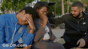 A Man In A Blue Nike Jacket Is Comforting Another Man And Woman GIF