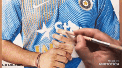A Man In A Blue Nike Shirt Is Being Painted By Someone GIF