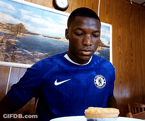A Man In A Blue Nike Shirt Looks At A Pie GIF