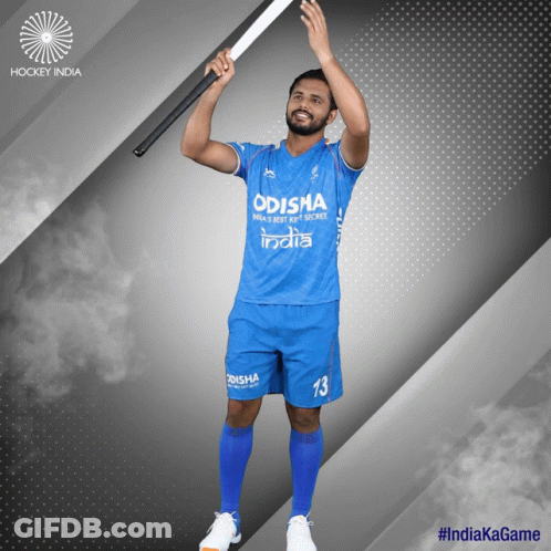 A Man In A Blue Odisha Jersey Holds Up A Hockey Stick GIF