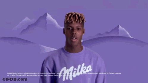 A Man In A Blue Oreo Shirt Is Holding A Bar Of Oreo GIF