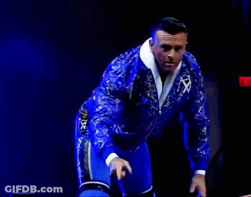 A Man In A Blue Paisley Jacket Is Giving A Thumbs Up GIF