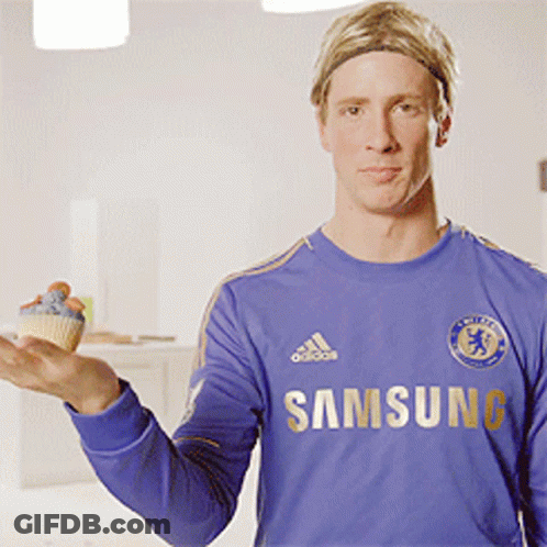 A Man In A Blue Samsung Shirt Holds A Cupcake GIF
