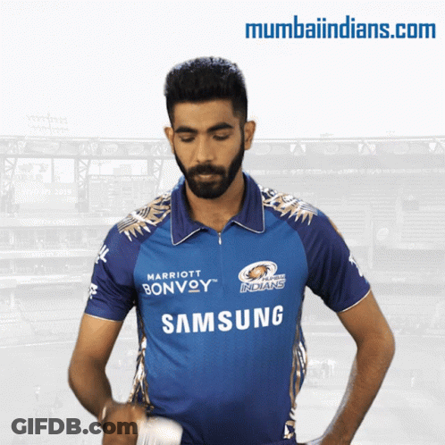 A Man In A Blue Samsung Shirt Stands In Front Of A Stadium GIF