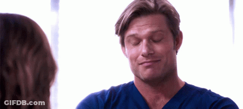Man In Blue Scrub Top Looking At Woman GIF