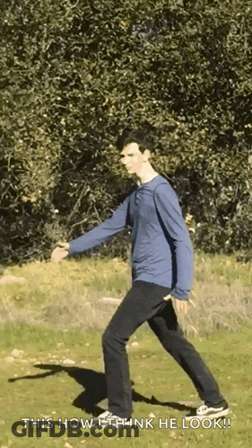 A Man In A Blue Shirt And Black Pants Is Walking In A Field With The Words " This How I Think He Look " Below Him GIF