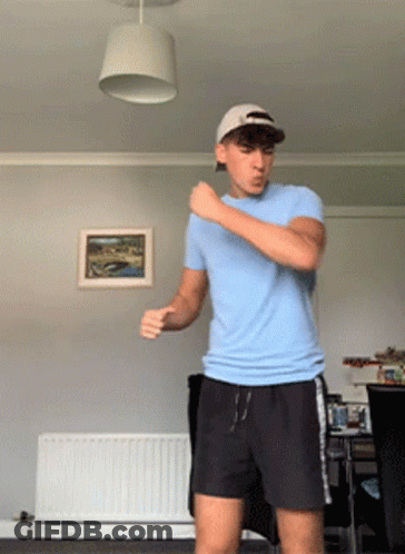 Man In Blue Shirt And Black Shorts Dancing GIF
