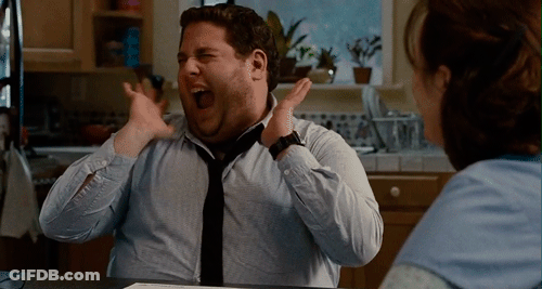 A Man In A Blue Shirt And Black Tie Is Laughing GIF