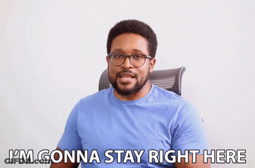 A Man In A Blue Shirt And Glasses Says I 'M Gonna Stay Right Here GIF