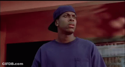 A Man In A Blue Shirt And Hat Is Standing In Front Of A Red Wall And Talking About Going To Cry In The Car . GIF