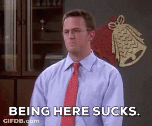 A Man In A Blue Shirt And Red Tie Is Saying Being Here Sucks GIF