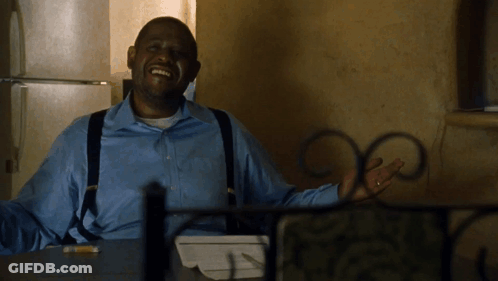 A Man In A Blue Shirt And Suspenders Is Smiling GIF