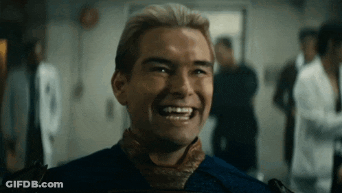 A Man In A Blue Shirt And Tie Is Laughing In A Room With Other People . GIF