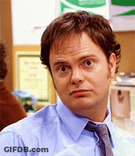 A Man In A Blue Shirt And Tie Is Looking At The Camera GIF