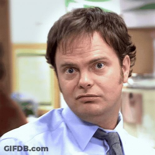 A Man In A Blue Shirt And Tie Is Making A Face GIF