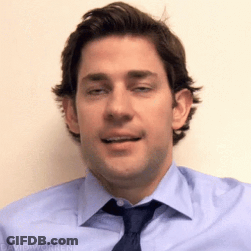 A Man In A Blue Shirt And Tie Is Making A Face . GIF