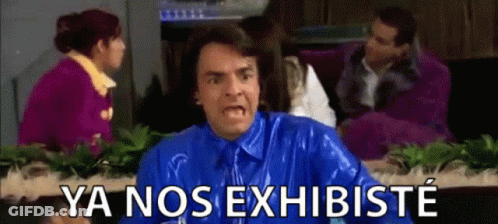A Man In A Blue Shirt And Tie Is Making A Funny Face And Says Ya Nos Exhibiste GIF